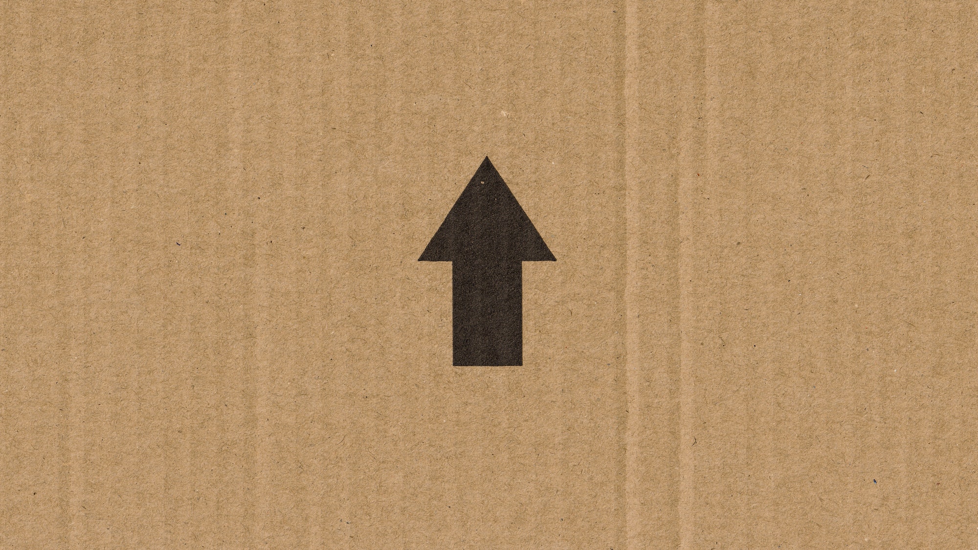 black arrow on a cardboard box