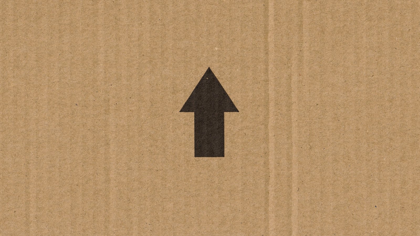 black arrow on a cardboard box